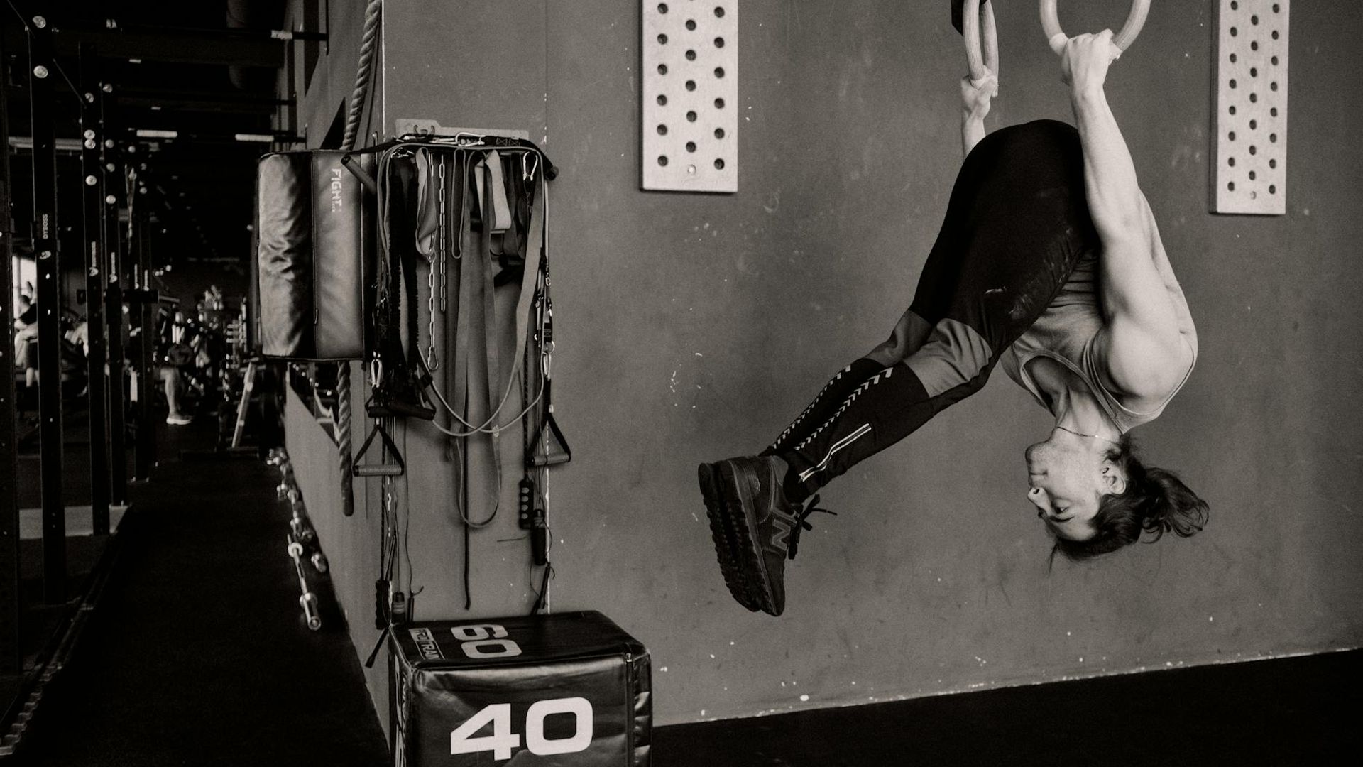 Athletic man performing strength exercises in a minimalist modern gym.