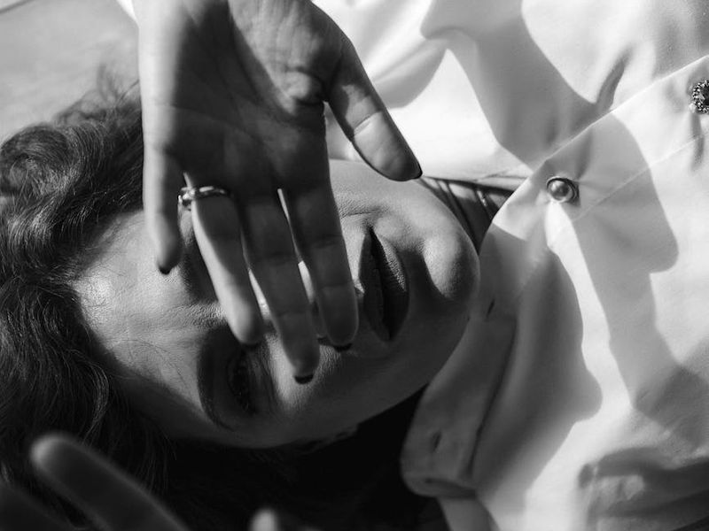 Black and white shot of a man's hands gripping a bar.