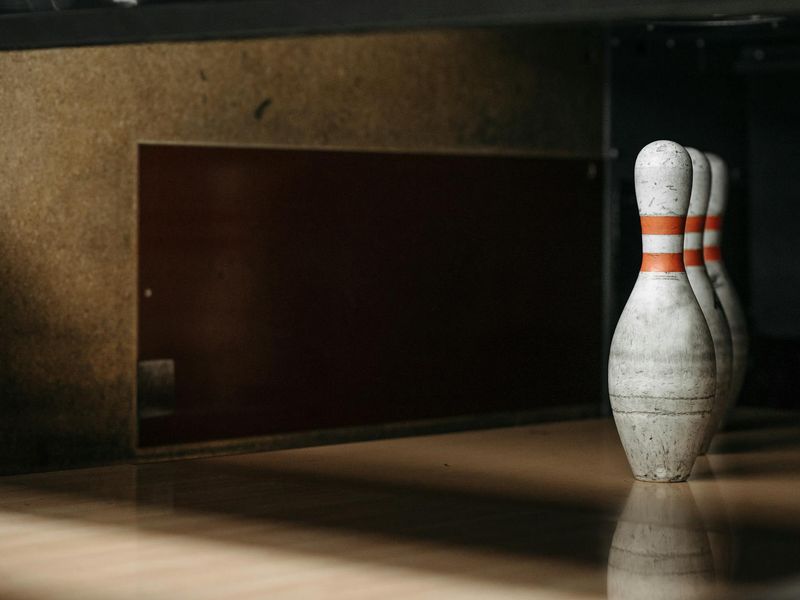 Close up of sports equipment on a wooden floor with soft morning light.